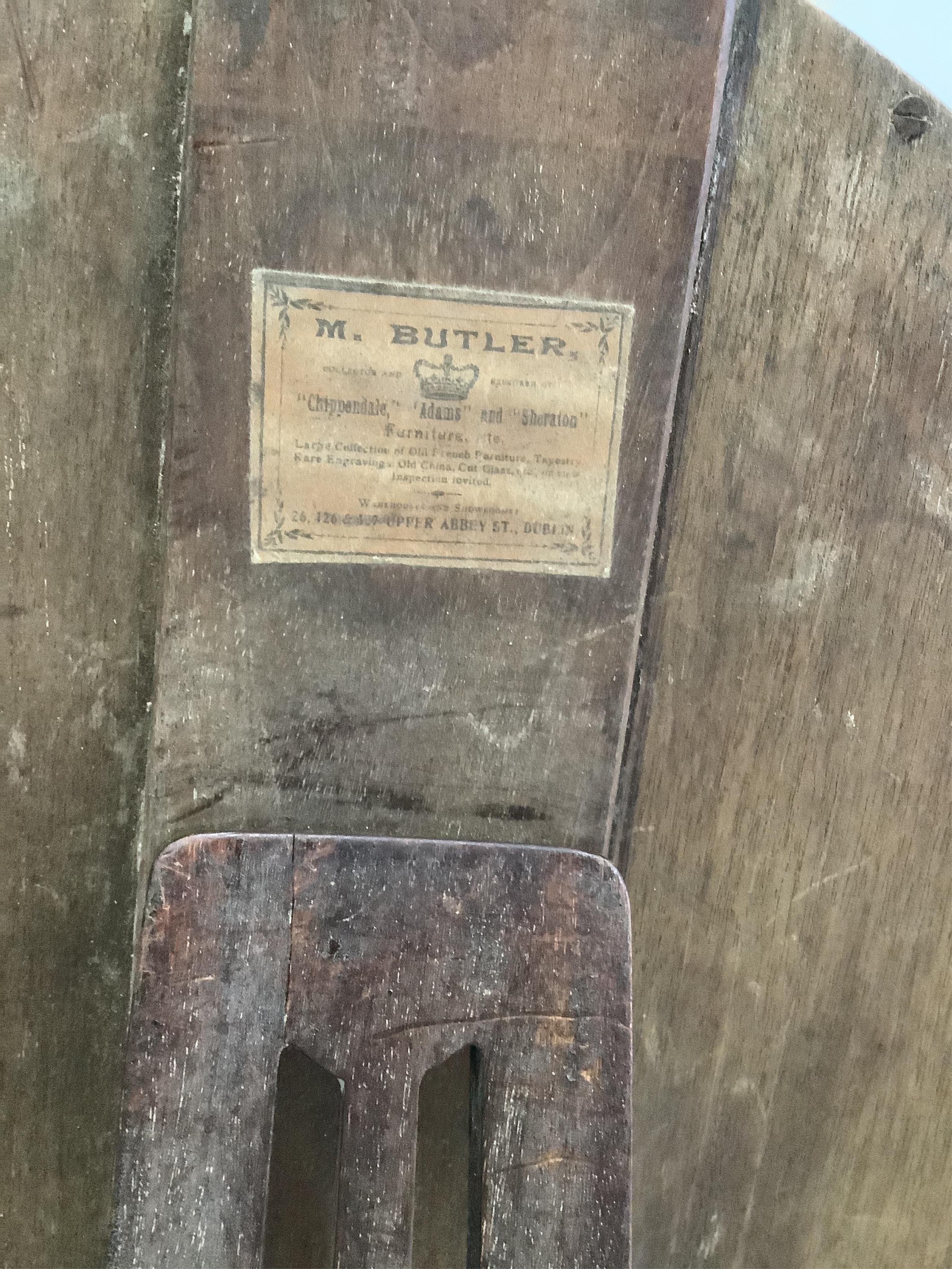 An early 20th century Irish glass bead applied mahogany toilet mirror, modelled in the 18th century manner and with label for M Butler of Dublin, width 40cm, height 62cm. Condition - fair